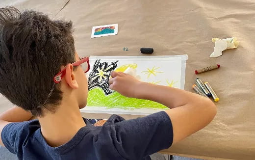 a person painting on a white board