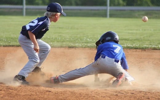 a baseball player sliding into home plate