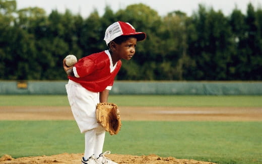 a kid pitching a baseball