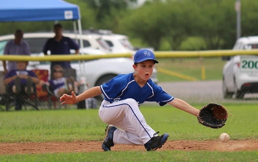 a young boy pitching a baseball