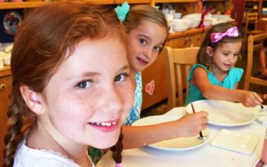 a group of children sitting at a table