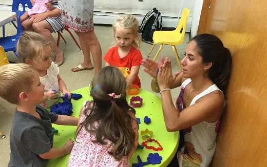 a group of children sitting around a table