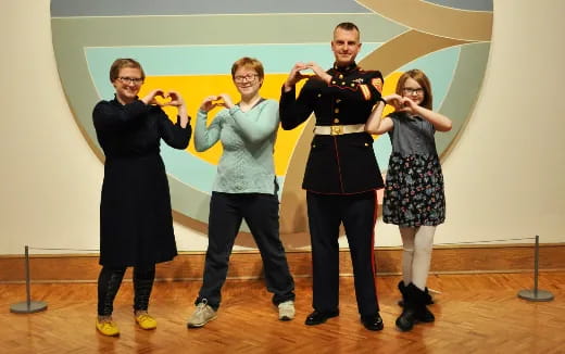 a group of people holding objects posing for the camera