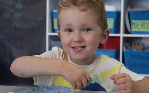 a young boy holding a toothbrush