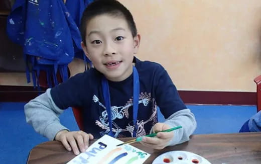 a boy sitting at a table