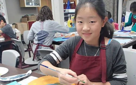 a young girl sitting at a table