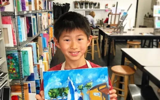 a boy holding a book