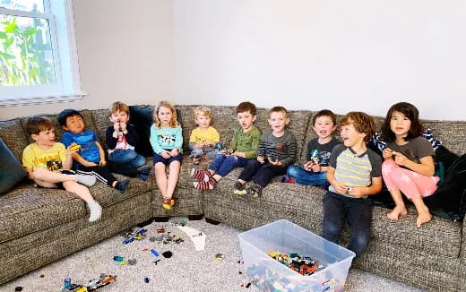 a group of children sitting on a couch