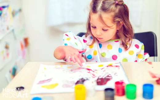 a girl coloring on a paper