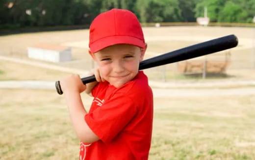 a boy holding a baseball bat