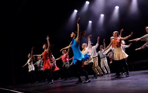 a group of people dancing on a stage