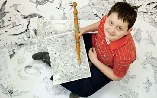 a boy holding a pencil