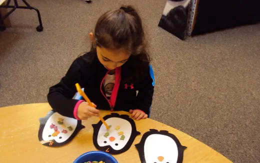 a child painting on a table