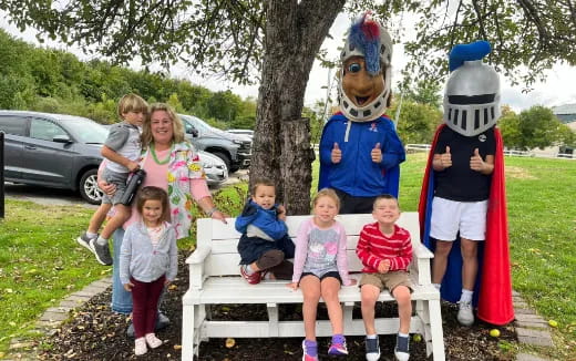 a group of kids posing with people in clothing