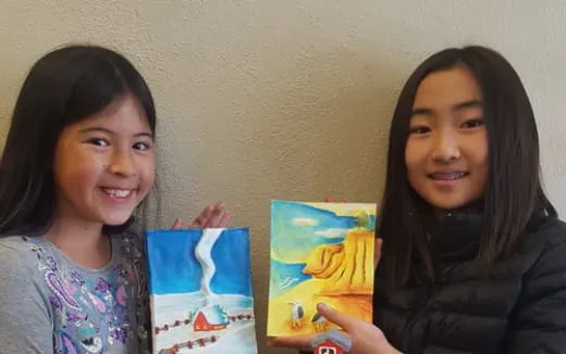 a couple of girls holding books