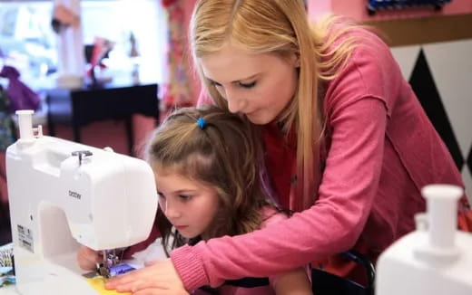 a person and a child looking at a microscope