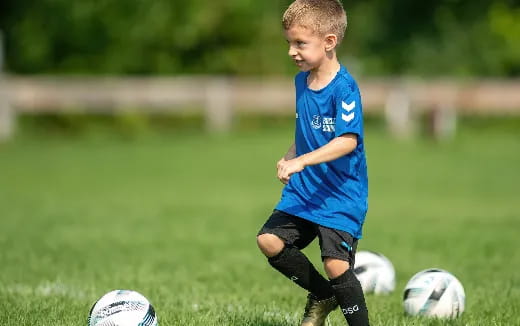 a young boy playing football