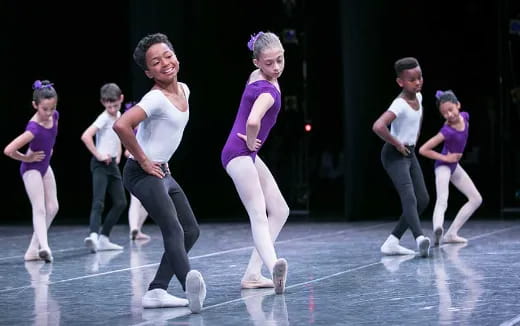 a group of people dancing on a stage