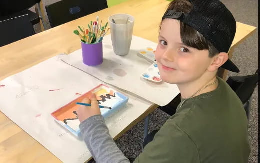 a boy sitting at a table