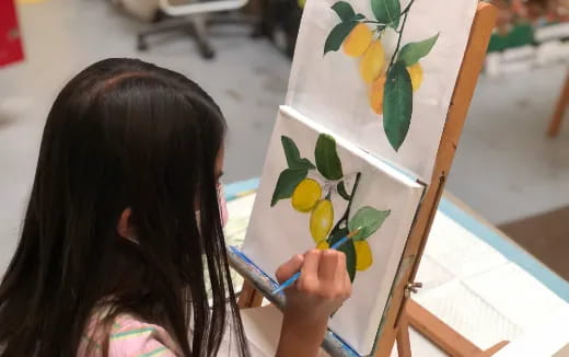 a girl painting a tree