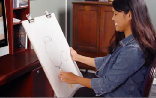 a person drawing on a white board