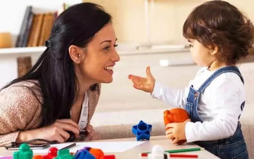 a woman and a child playing with toys