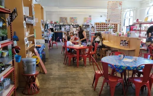 a group of children sitting at tables in a library