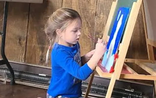 a young girl painting