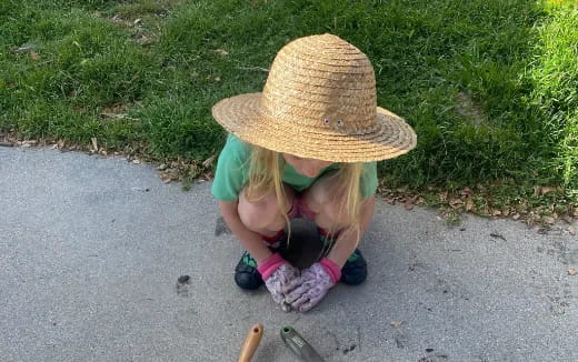 a little girl wearing a straw hat