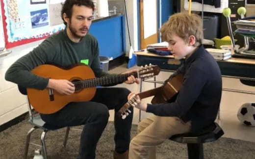 a couple of boys playing guitars