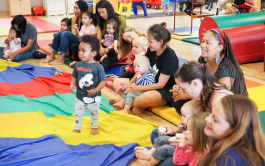 a group of children sitting on a mat