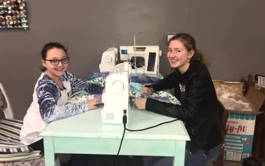 a couple of women working on a computer