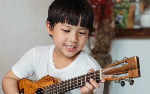 a child playing a guitar