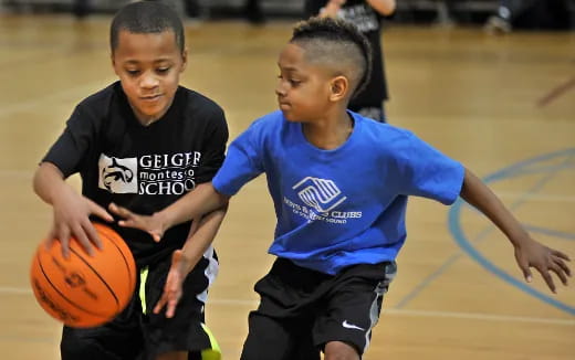 a couple of boys playing basketball