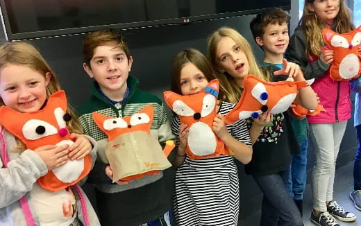 a group of children holding stuffed animals