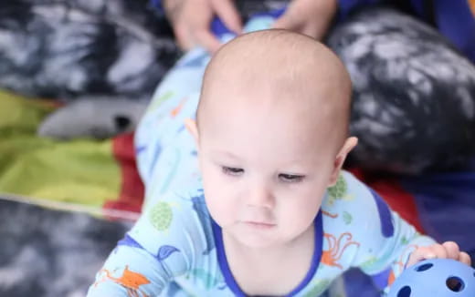 a baby lying on a blanket