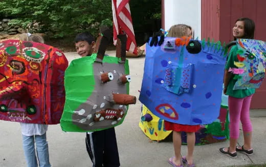 a group of children holding shields