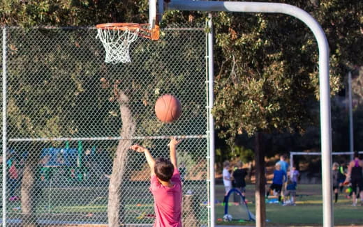 a boy shooting a basketball