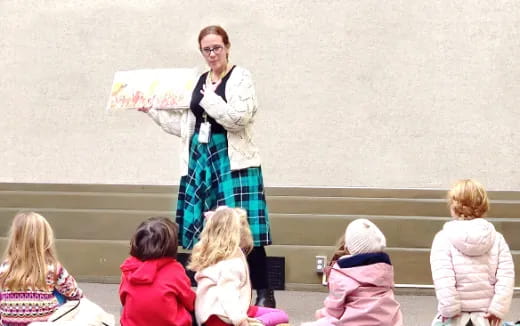 a person standing in front of a group of children