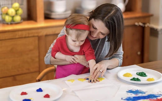 a person and a child painting