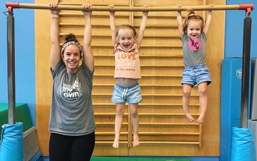 a person and two children on a bar