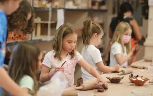 a group of children sitting at a table