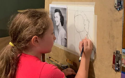 a person drawing on a white board