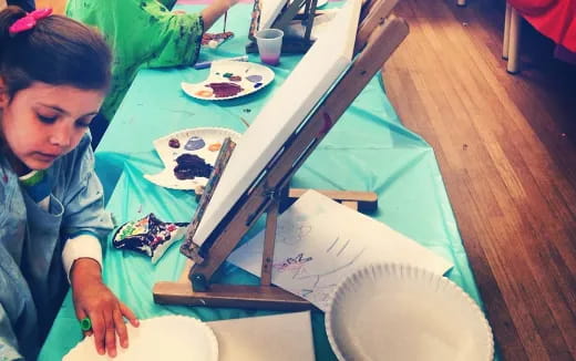 a girl painting on a table