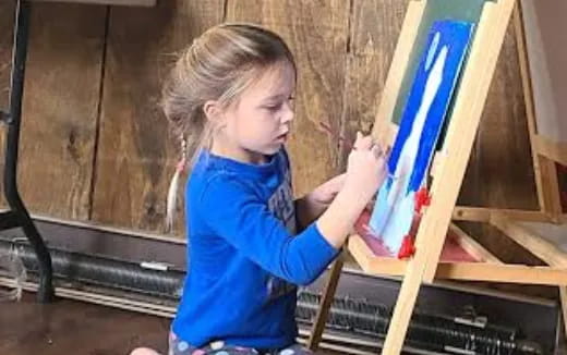 a young girl painting