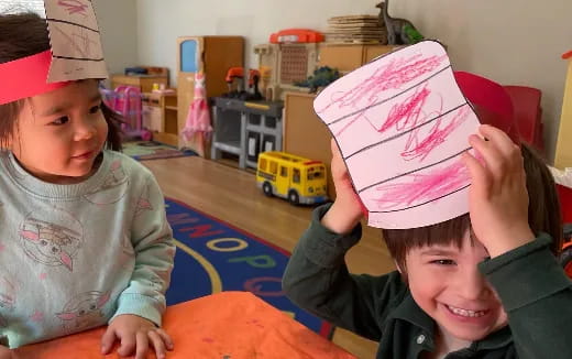a couple of kids wearing paper crowns