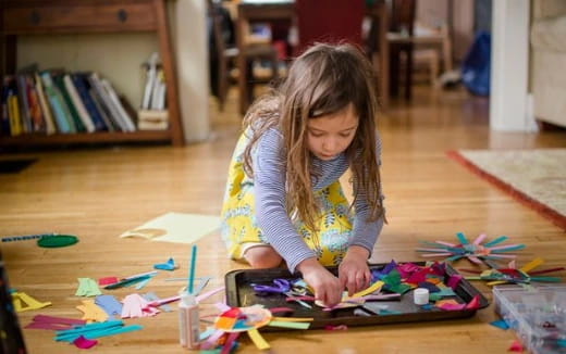 a girl coloring on a paper