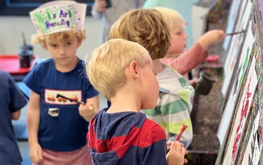 a group of children looking at a display case