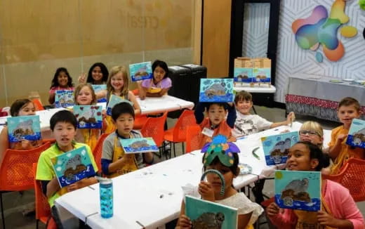 a group of children sitting at a table