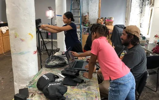 a group of people working on a laptop